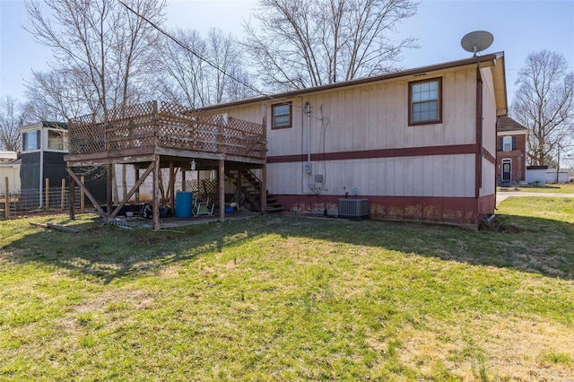 rear view of house featuring central air condition unit, a lawn, a deck, and stairway