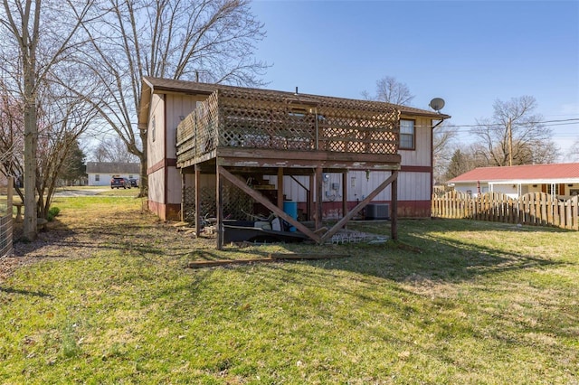 back of property featuring central AC unit, fence, a wooden deck, stairs, and a lawn