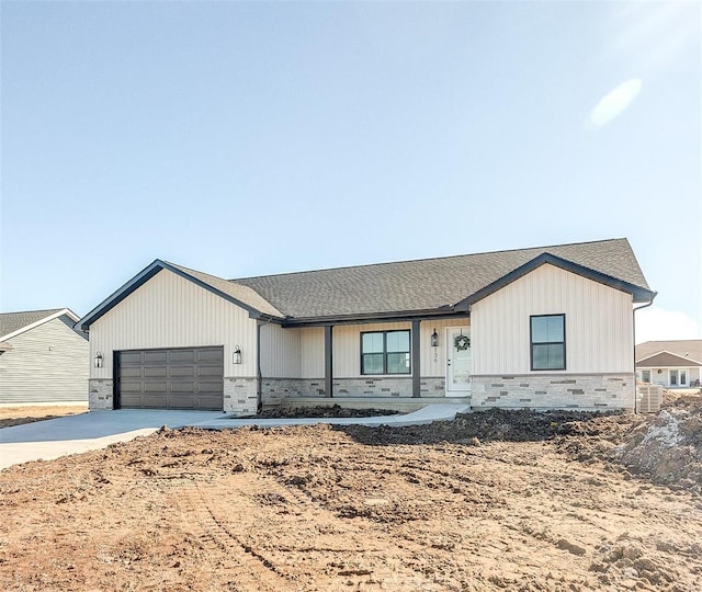 view of front facade featuring cooling unit, driveway, and a garage