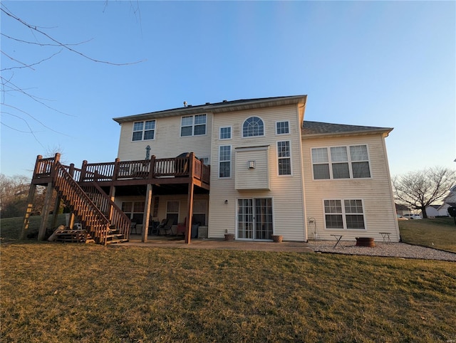 rear view of property featuring a deck, stairway, a yard, and a patio area