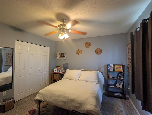 carpeted bedroom featuring a closet, a textured ceiling, and ceiling fan