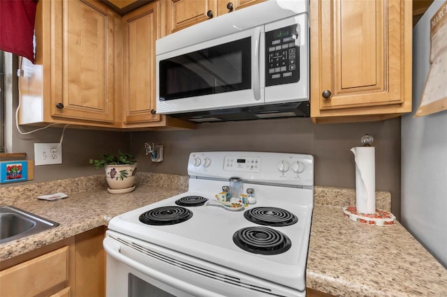 kitchen featuring white appliances and light countertops