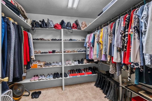 walk in closet with carpet flooring