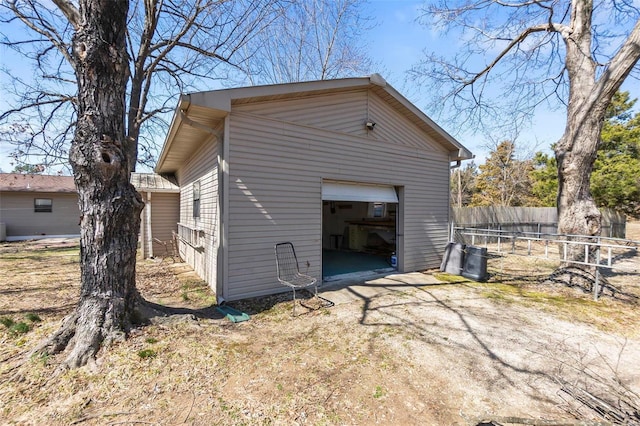 garage with driveway and fence