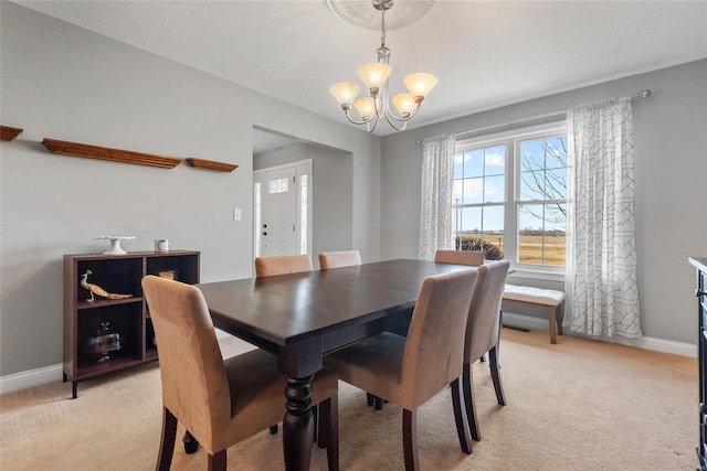 dining space with baseboards, light colored carpet, and an inviting chandelier