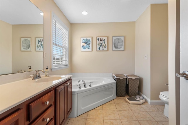 full bath with tile patterned flooring, baseboards, toilet, a garden tub, and vanity