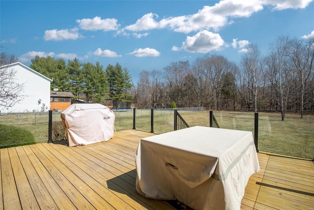 wooden deck with a lawn and a fenced backyard