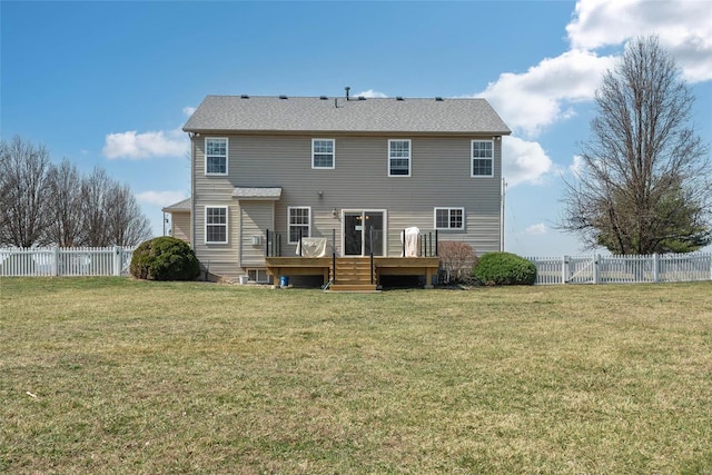 back of house with a yard, a fenced backyard, and a wooden deck