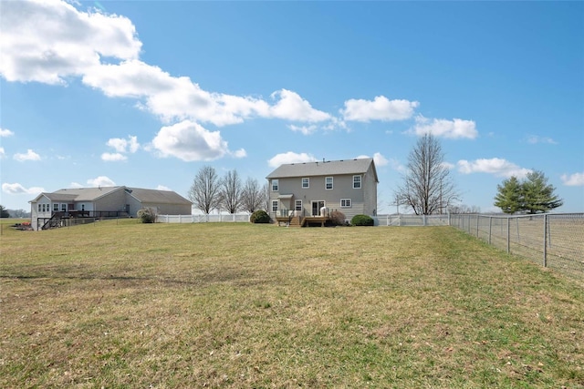 view of yard with a fenced backyard and a deck