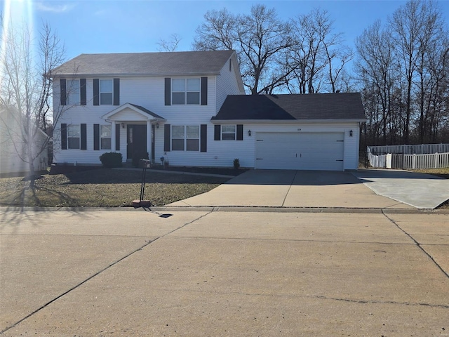 colonial inspired home featuring driveway, a garage, and fence