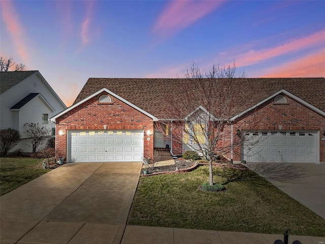 ranch-style home with brick siding, an attached garage, and concrete driveway