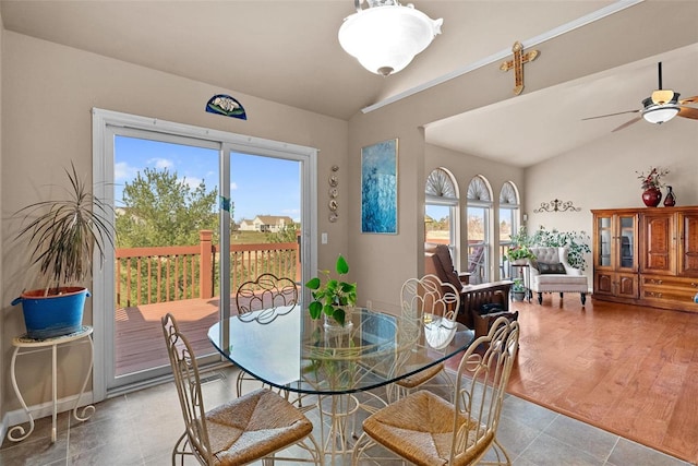 dining area featuring a healthy amount of sunlight, ceiling fan, and vaulted ceiling