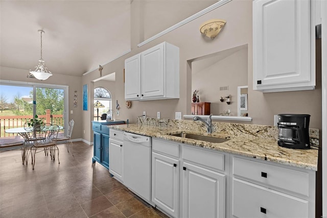 kitchen featuring dishwasher, lofted ceiling, white cabinets, and a sink