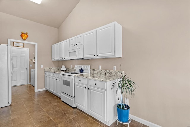 kitchen with baseboards, lofted ceiling, light stone counters, white cabinets, and white appliances