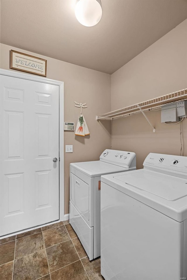 washroom featuring laundry area and separate washer and dryer