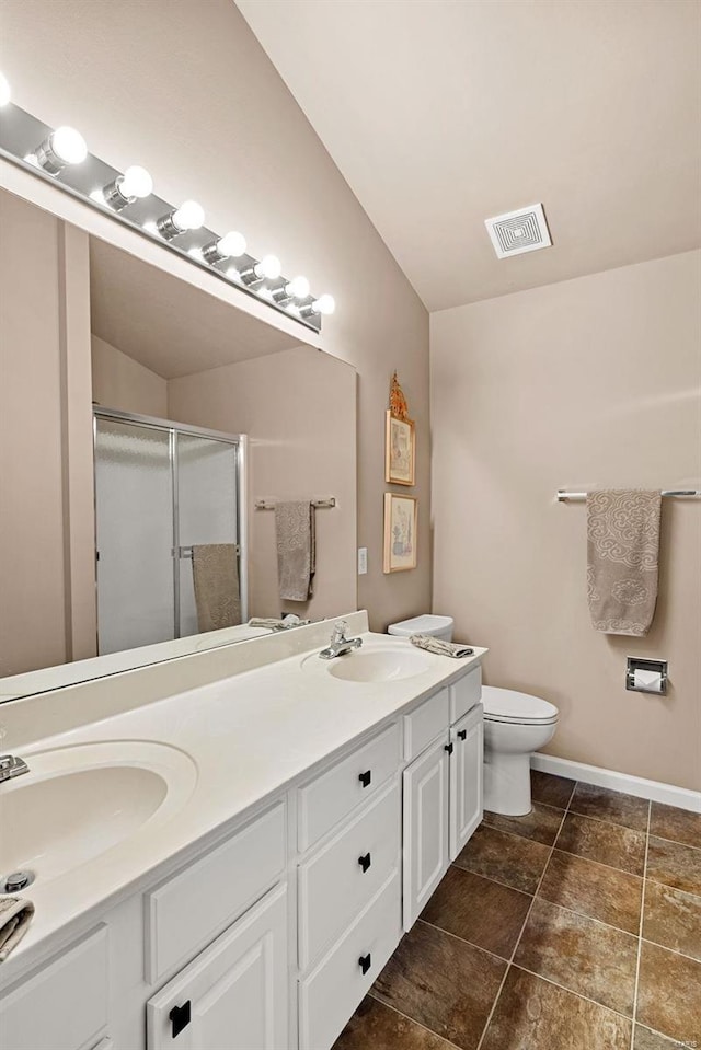 full bath with double vanity, a stall shower, visible vents, and a sink