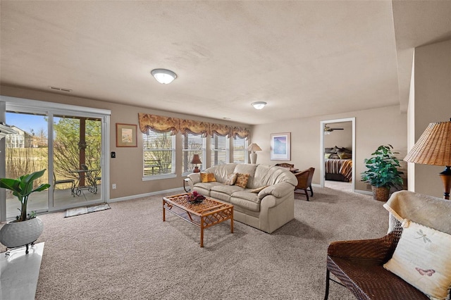 living room featuring visible vents, baseboards, and carpet floors