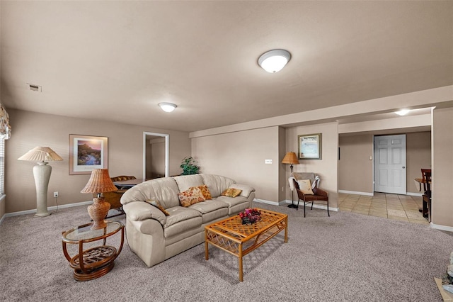 carpeted living area with tile patterned flooring and baseboards