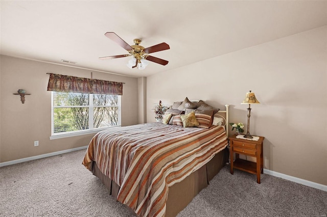 carpeted bedroom with visible vents, baseboards, and a ceiling fan