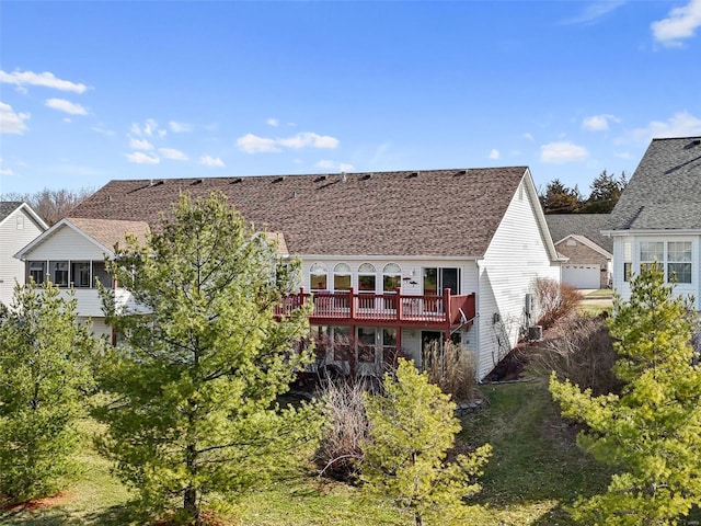 back of house featuring a wooden deck