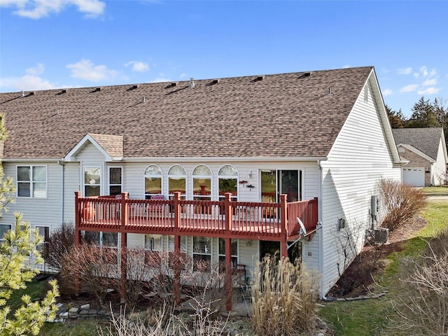 back of house featuring a wooden deck, central AC, and a shingled roof