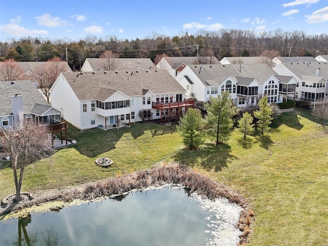 drone / aerial view with a residential view and a water view