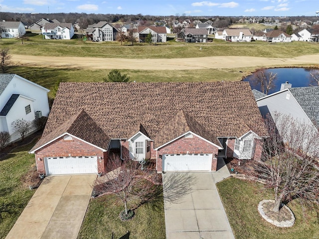 birds eye view of property featuring a residential view and a water view