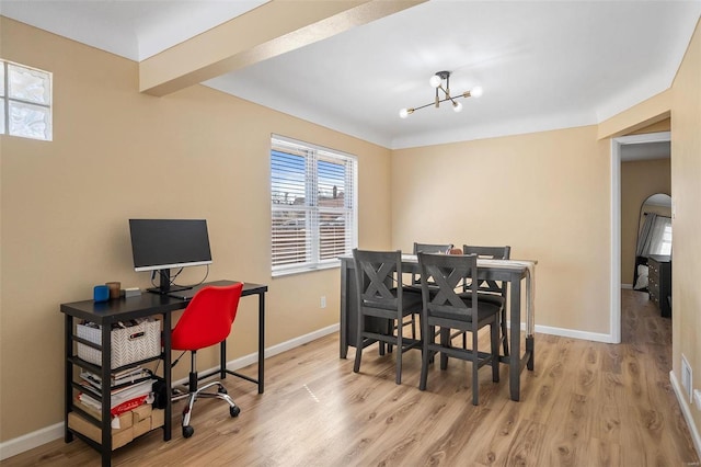 dining space with wood finished floors, baseboards, and a chandelier