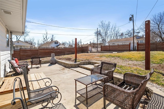 view of patio / terrace with an outdoor structure and a fenced backyard