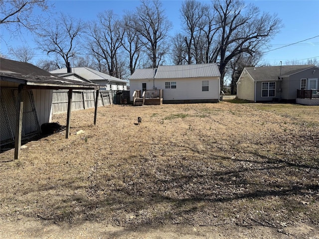 view of yard with a deck and fence