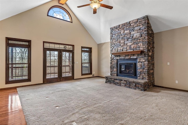 unfurnished living room with a fireplace, carpet, a ceiling fan, and high vaulted ceiling