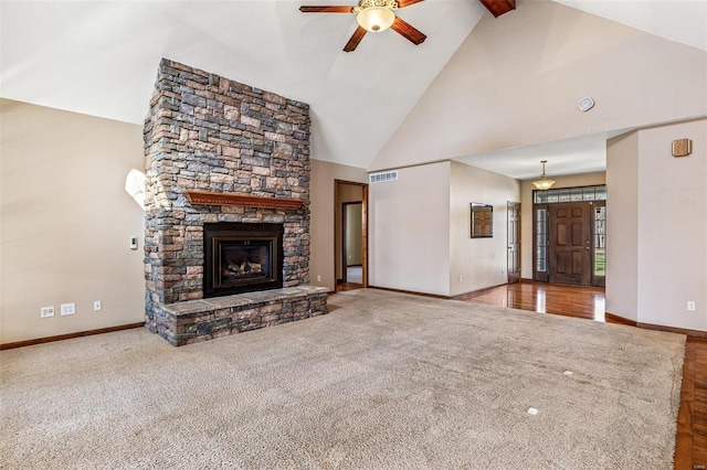 unfurnished living room featuring visible vents, a fireplace, ceiling fan, and carpet floors