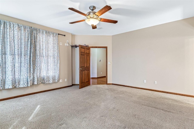 unfurnished room with carpet, baseboards, and ceiling fan