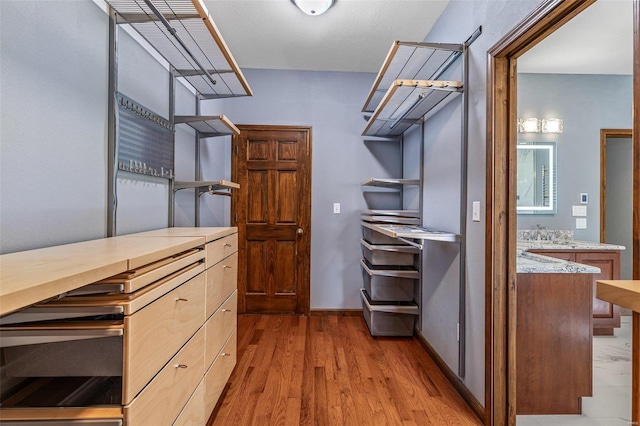 walk in closet featuring light wood-style floors