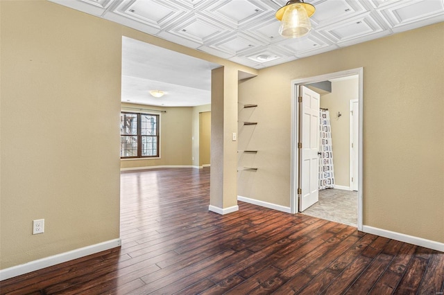 unfurnished room featuring hardwood / wood-style flooring, baseboards, and an ornate ceiling