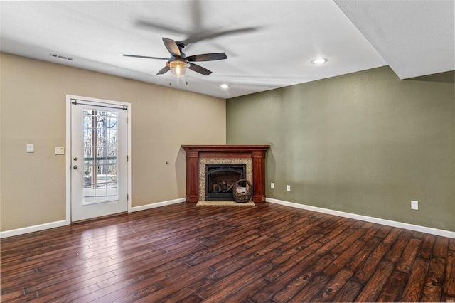 unfurnished living room featuring visible vents, wood-type flooring, baseboards, and a ceiling fan