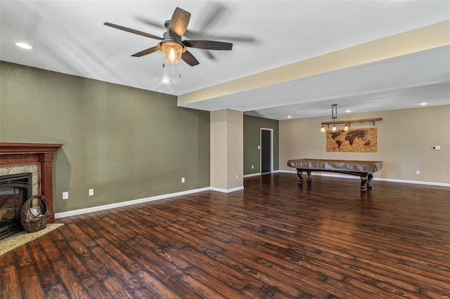 unfurnished living room with baseboards, a fireplace, wood finished floors, billiards, and a ceiling fan