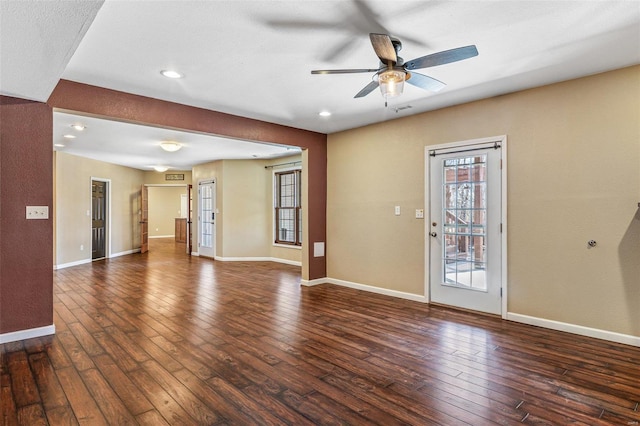 unfurnished living room featuring baseboards, ceiling fan, and hardwood / wood-style flooring