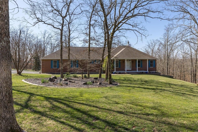 view of front of property with brick siding, a porch, and a front yard