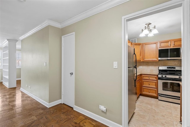 kitchen featuring backsplash, baseboards, ornamental molding, stainless steel appliances, and ornate columns