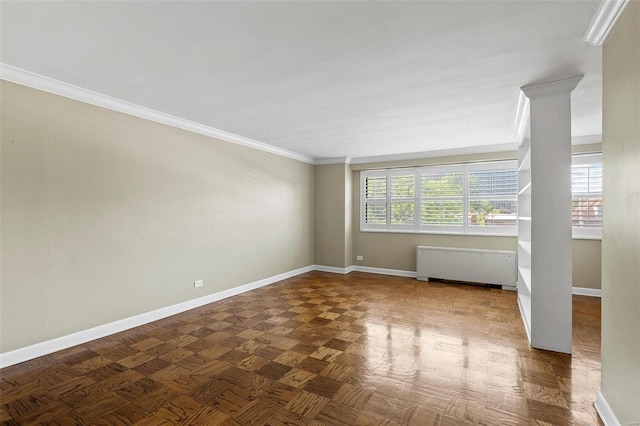 empty room with crown molding and baseboards