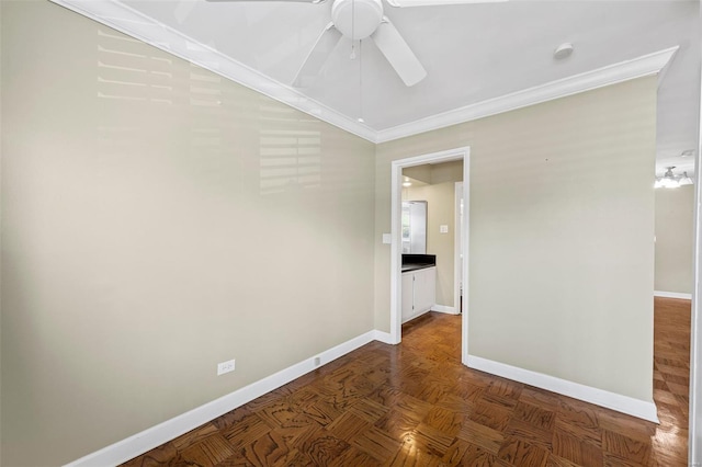 empty room featuring baseboards, a ceiling fan, and crown molding
