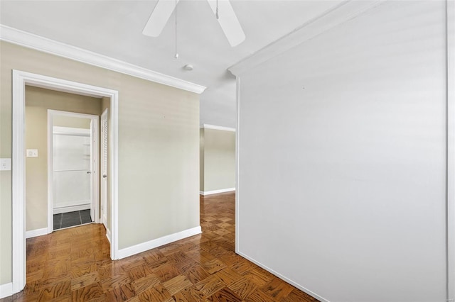 spare room with crown molding, baseboards, and ceiling fan