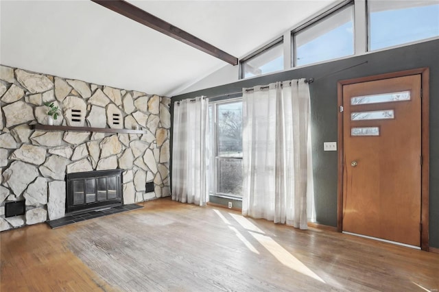 unfurnished living room with lofted ceiling with beams and wood finished floors