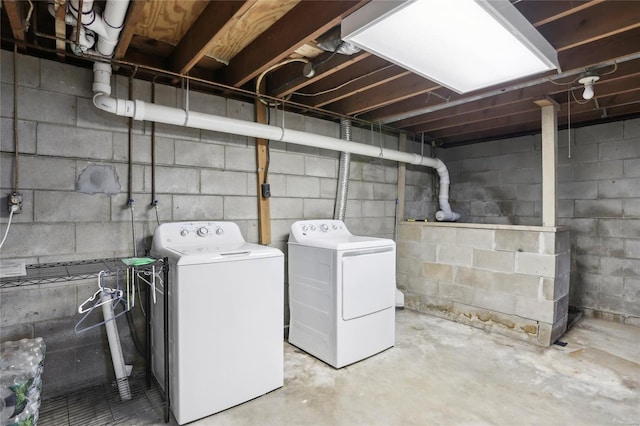 clothes washing area featuring laundry area and washing machine and clothes dryer