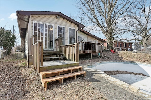 back of house with a wooden deck, central AC, and fence