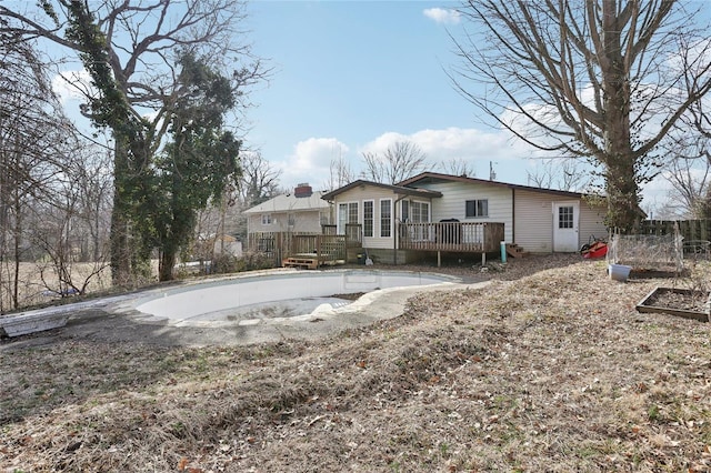 back of house featuring a wooden deck