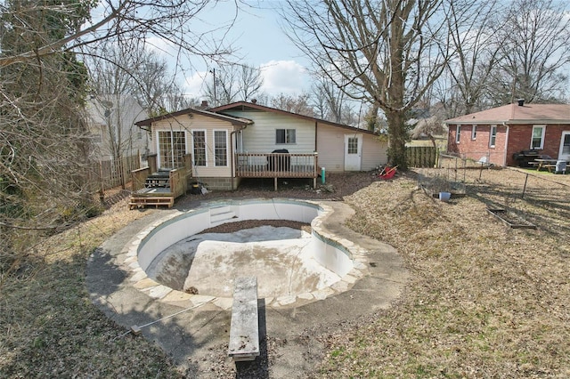 back of house with a deck and fence