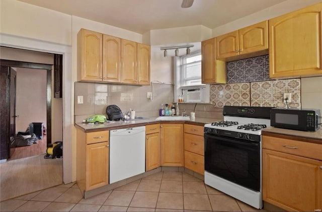 kitchen with black microwave, white dishwasher, light tile patterned floors, decorative backsplash, and gas range