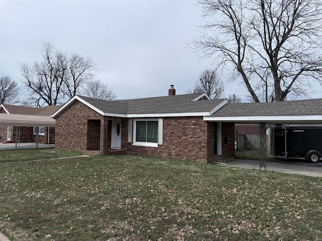 ranch-style house featuring a chimney, roof with shingles, a front yard, a carport, and brick siding